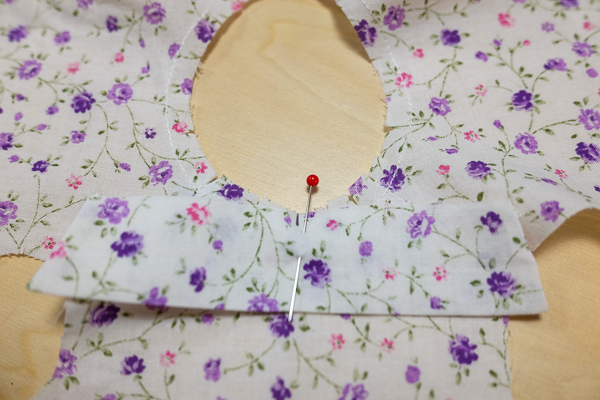 Begin to sew the collar on the neckline